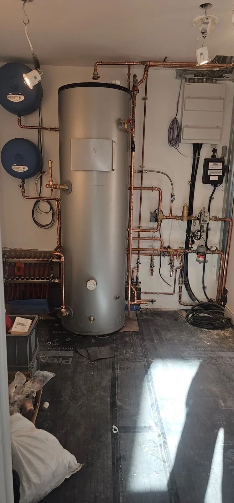 Hot water cylinder and wall-mounted heating controls