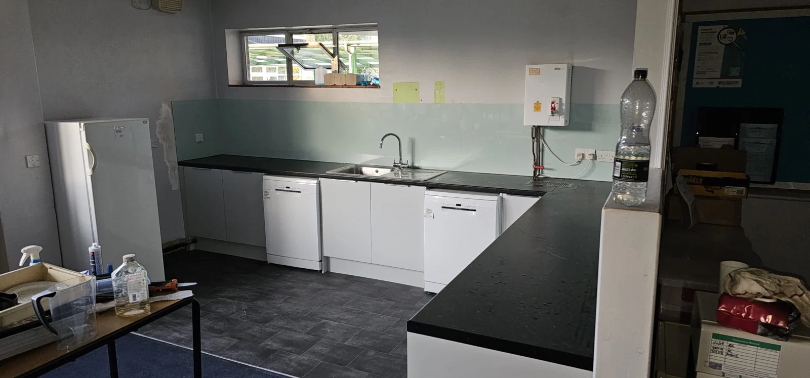 Fitted white kitchen and dark worktops